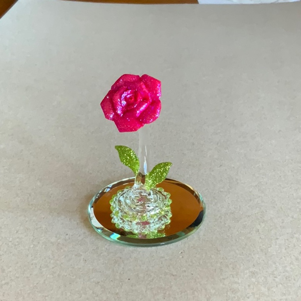 Glass rose on mirror